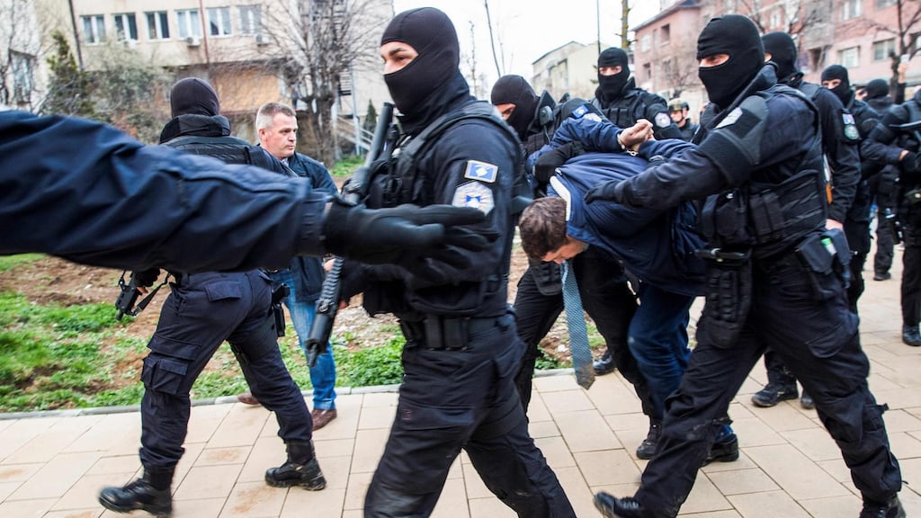Serbia’s chief negotiator in EU-brokered talks on Kosovo, Marko Djuric, is frogmarched down a street in Pristina by Kosovan police officers on Monday. Photograph: AFP/Getty Images