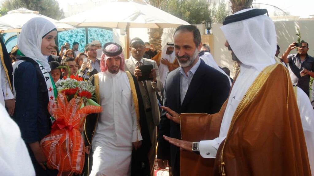Syrian National Coalition leader Moaz Alkhatib (second from right) arrives at the opening of its embassy in Doha, Qatar, yesterday.  A Syrian opposition bloc recognised by the Arab League as the sole representative for Syria has opened its first embassy there.  Photograph: Mohammed Dabbous