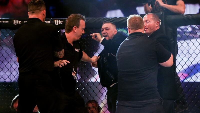 Conor McGregor is held back by officials after entering the octagon at the Bellator 187 and BAMMA 32 show at the 3 Arena following the fight between John Redmond and Charlie Ward. Photograph: Gary Carr/Inpho