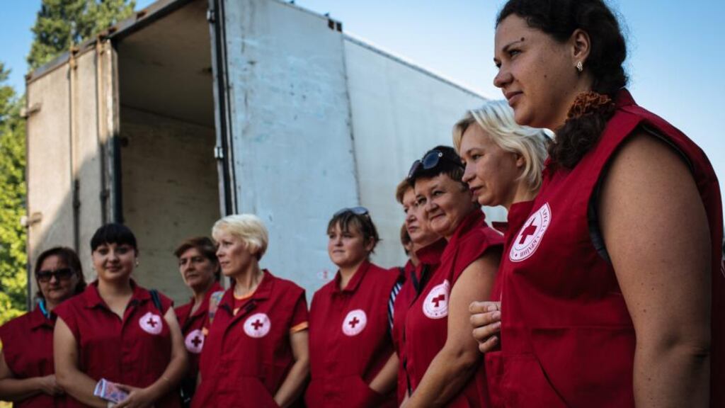 Members of the International Committee of the Red Cross stand near a storehouse after a Ukrainian convoy delivered humanitarian aid for eastern Ukrainian regions. The number of attacks on aid workers last year set an annual record, at 460. Photograph: Roman Pilpey/EPA
