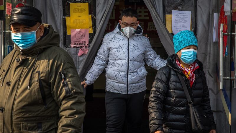 People wearing protective face masks leave a supermarket at Hutong neighborhood, Beijing. Photograph: Roman Pilipey/EPA
