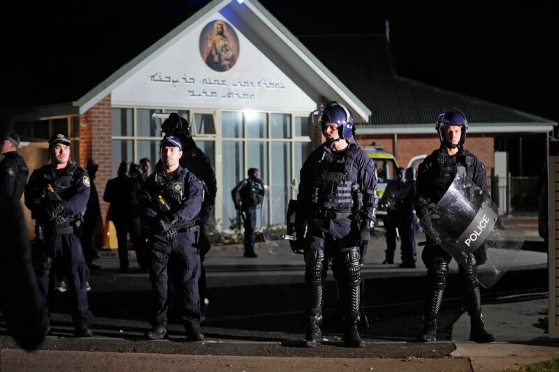 A crowd of hundreds seeking revenge gathered outside the Orthodox Assyrian church. Photograph: Mark Baker/AP