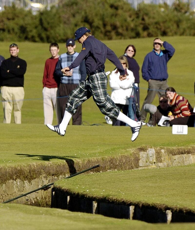 England’s Ian Poulter jumps the Swilken burn at the first hole on the Old Course. Photograph: Andrew Milligan/PA