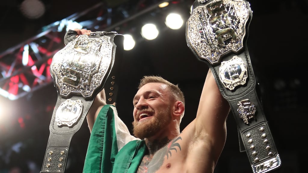 Conor McGregor celebrates winning his second title. Photograph: Tom Hogan/Inpho