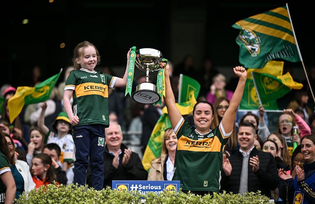 Danielle O'Leary of Kerry lifts the trophy with Grace Dumigan, from Killarney. Photograph: Sam Barnes/Sportsfile