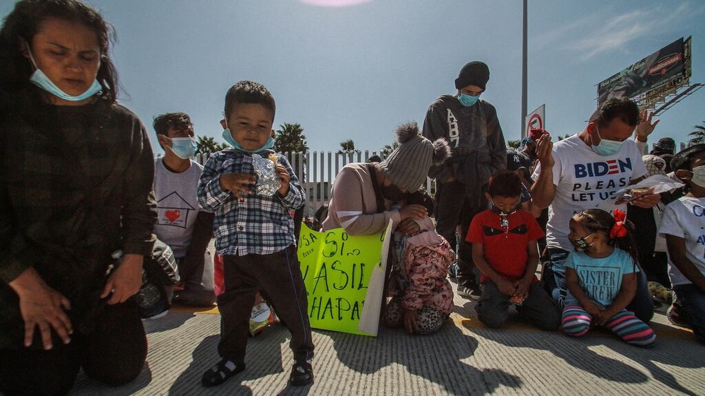 Migrant families pray for the opening up of the United States border near the El Chaparral border crossing in Tijuana, Mexico. Photograph: Joebeth Terriquez/EPA