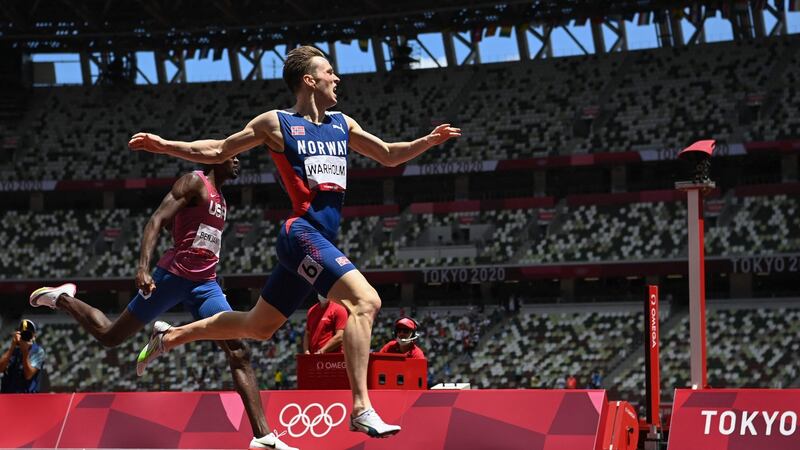 Karsten Warholm crosses the finish line to win break the world record in the men’s 400m hurdles. Photo: Jewel Samad/AFP via Getty Images