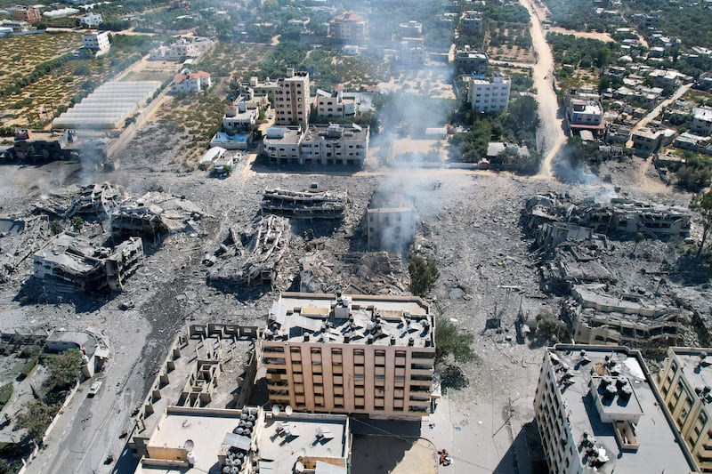 An aerial view shows smoke rising amid destoyed buildings in al-Zahra city, south of Gaza City, on Friday following Israeli bombardment overnight. Photograph: Belal Alsabbagh/AFP/Getty