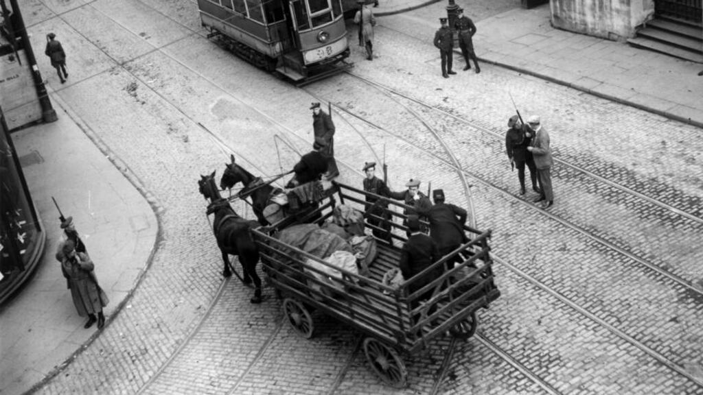 Auxiliaries (wearing Tam o’ Shanter bonnets) stop a postman with a GPO mail cart in Dublin. Photograph: Walshe/Getty Images