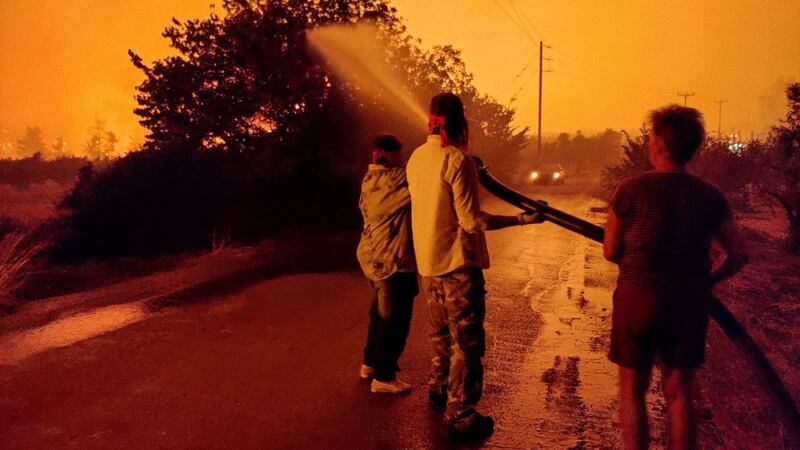 Residents battle to extinguish a wildfire burning in the area of Limni in Evia island off the coast of Greece. Photograph: Panagiotis Kouros/EPA