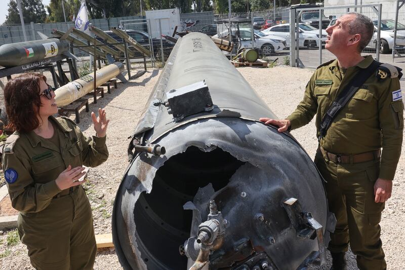 Israeli military spokesman rear admiral Daniel Hagari and his deputy Masha Michelson pose next to an Iranian ballistic missile which fell in Israel on the weekend. Photograph: Gil Cohen-Magen/AFP via Getty Images