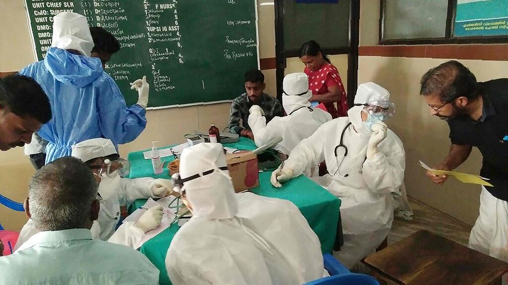 Medical personnel wearing protective suits check patients at the Medical College hospital in Kozhikode, Kerala, India following an outbreak of the Nipah virus. Photograph: AFP