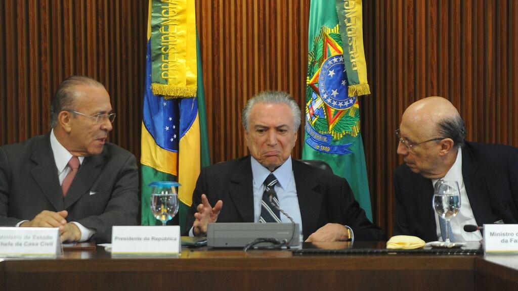 Brazil’s interim president Michel Temer(centre) sits between chief of staff Eliseu Padilha (left) and economy minister Henrique Meirelles during the first ministers meeting at the Planalto Palace in Brasilia on Friday. Photograph: Andressa Anholete/AFP