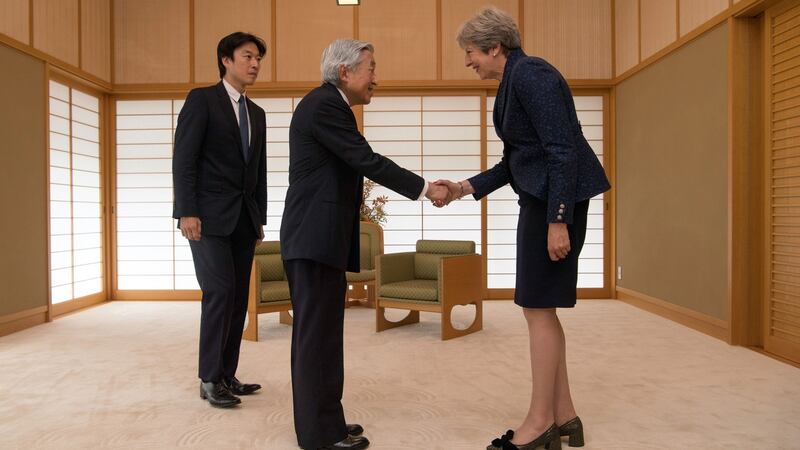 Britain’s prime minister Theresa May (R) is greeted by Emperor Akihito of Japan during her visit to the Royal Palace. Photograph:  Carl Court/Getty