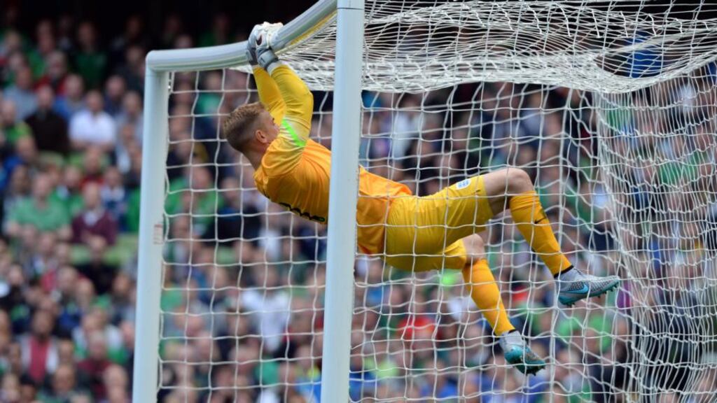 England goalkeeper Joe Hart swings from the crossbar after an off-target Irish effort during yesterday’s friendly at the Aviva Stadium. Photo: Eric Luke / The Irish Times
