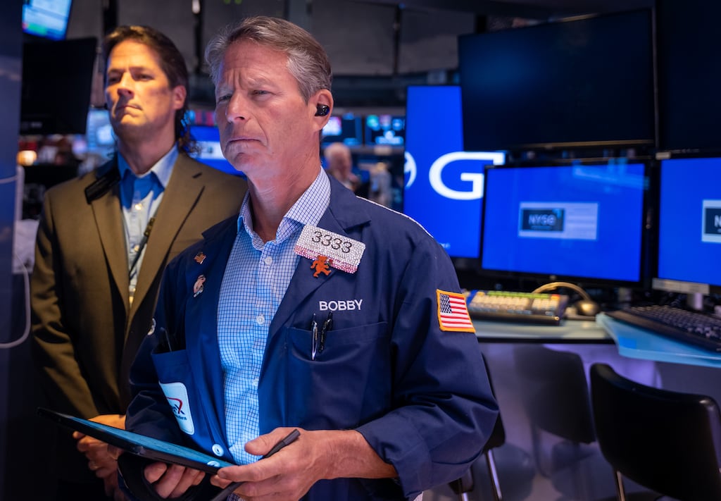 Wall Street’s main indexes slumped to their lowest in a week as fresh economic data tempered optimism around further interest rate cuts.