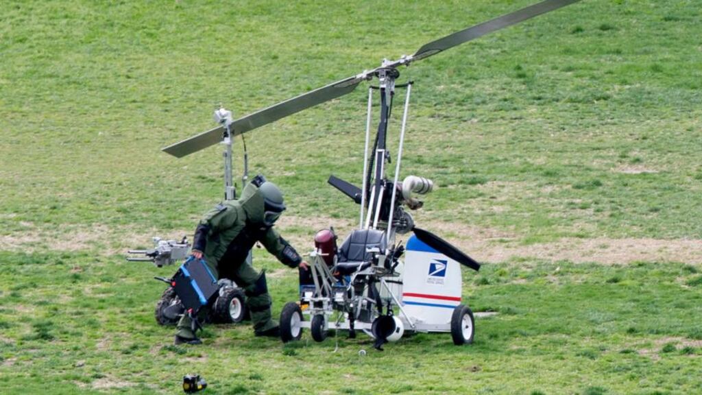 A member of a bomb squad works beside a bomb disposal robot and gyrocopter after it landed on the West Front of the US Capitol, on Capitol Hill in Washington. Photograph: Michael Reynolds/EPA