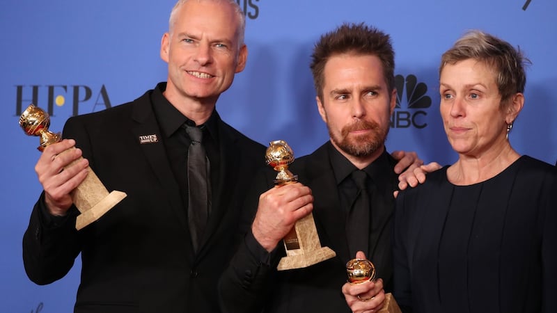 Martin McDonagh (L), winner for Best Screenplay - Motion Picture, Sam Rockwell, winner for Best Performance By An Actor In A Supporting Role In Any Motion Picture, and Frances McDormand, winner for Best Performance By An Actress In A Motion Picture - Drama, pose backstage after also winning the award for Best Motion Picture - Drama for “Three Billboards Outside Ebbing, Missouri.” Photograph:  Lucy Nicholson/Retuers