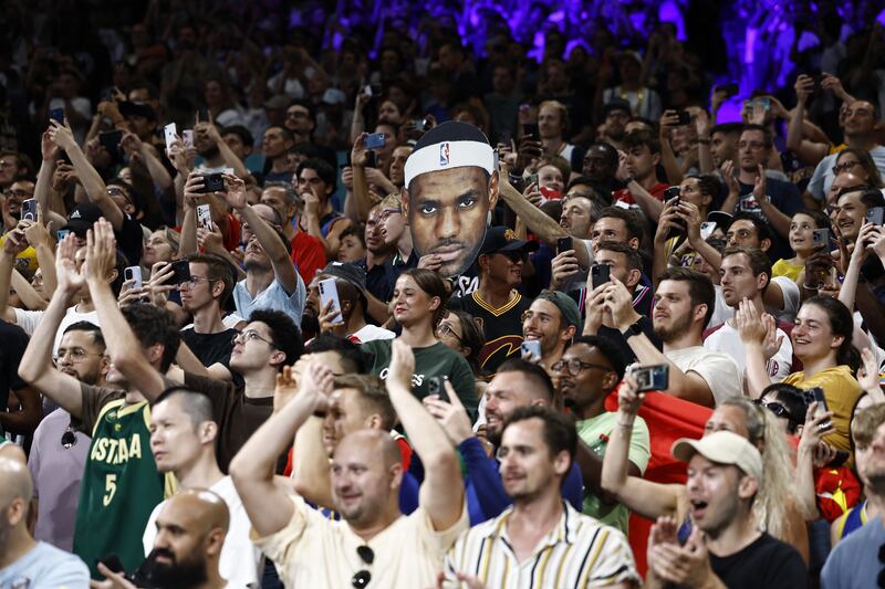 Fans hold a cut-out photo of the USA's LeBron James before his team's game against South Sudan at the Olympic Games in Paris. Photograph: Sameer Al-Doumy//AFP via Getty Images