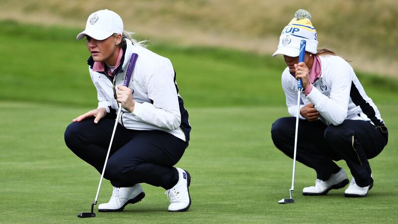 Charley Hull and Azahara Munoz line up putts during the 2019 Solheim Cup at Gleneagles. Photograph: Jamie Squire/Getty Images