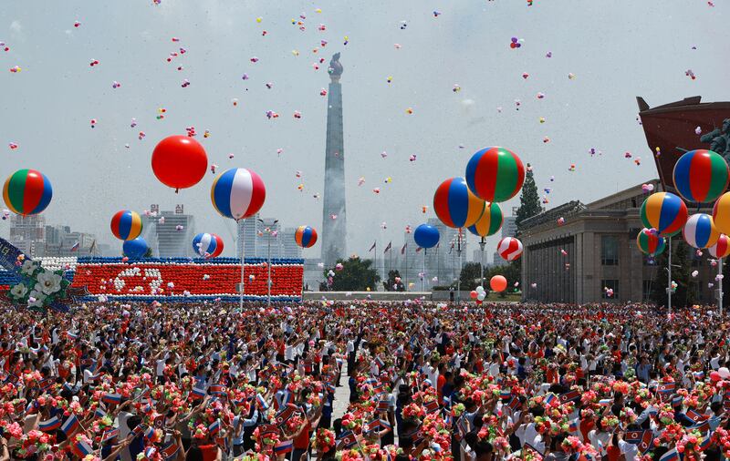 North Koreans release balloons as Russian president Vladimir Putin and North Korea's leader, Kim Jong-un, attend a welcoming ceremony in Pyongyang. Photograph: Vladimir Smirnov/Pool/AFP via Getty
