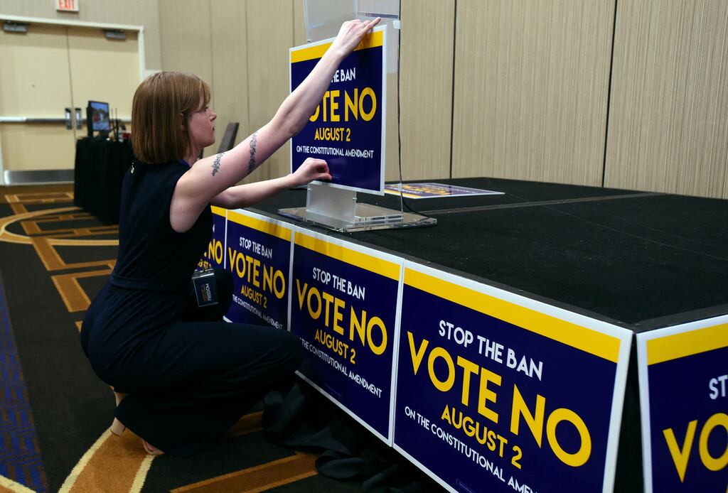 Field organiser Jae Grey places signs on the podium before the pro-choice Kansas for Constitutional Freedom election-watch party in Overland Park, Kansas, on August 2nd. Photograph: DAVE KAUP/AFP via Getty Images