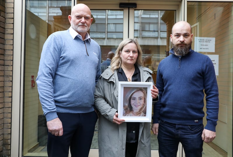 Chris, Alison and Gregory Sainsbury hold a photo of Byronny Sainsbury
outside the Coroners Court on Store Street, Dublin. Photograph: Gareth Chaney/Collins