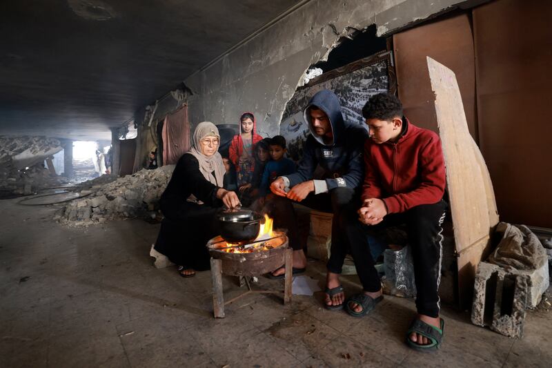 Displaced Palestinians prepare food as they take shelter inside a building damaged during an Israeli bombardment in Rafah in the southern Gaza Strip. Photograph: AFP via Getty Images