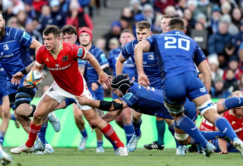 Munster’s Tom Farrell tries to evade the tackle by Caelan Doris of Leinster. Photograph: Tom Maher/Inpho