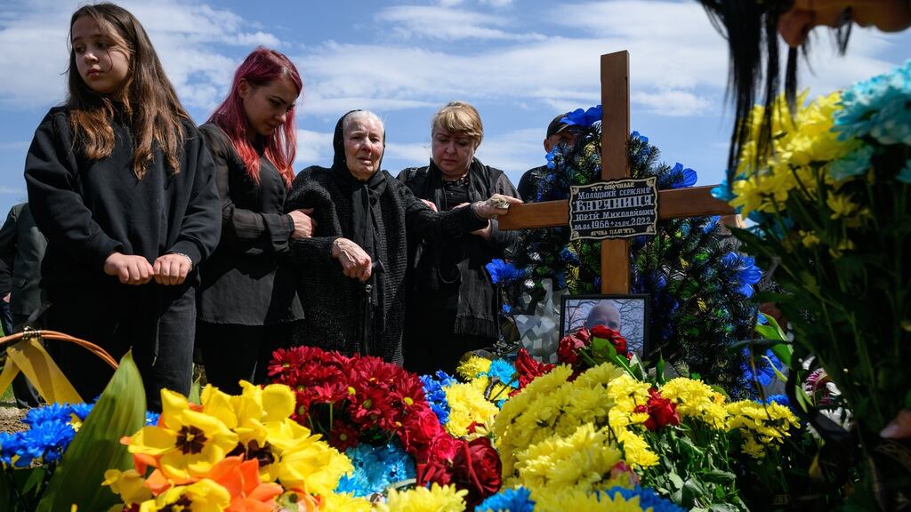 A graveside in Lviv. Russia’s bombing of a school in the eastern Ukrainian village of Bilohorivka has killed two people. File photograph: Leon Neal/Getty Images