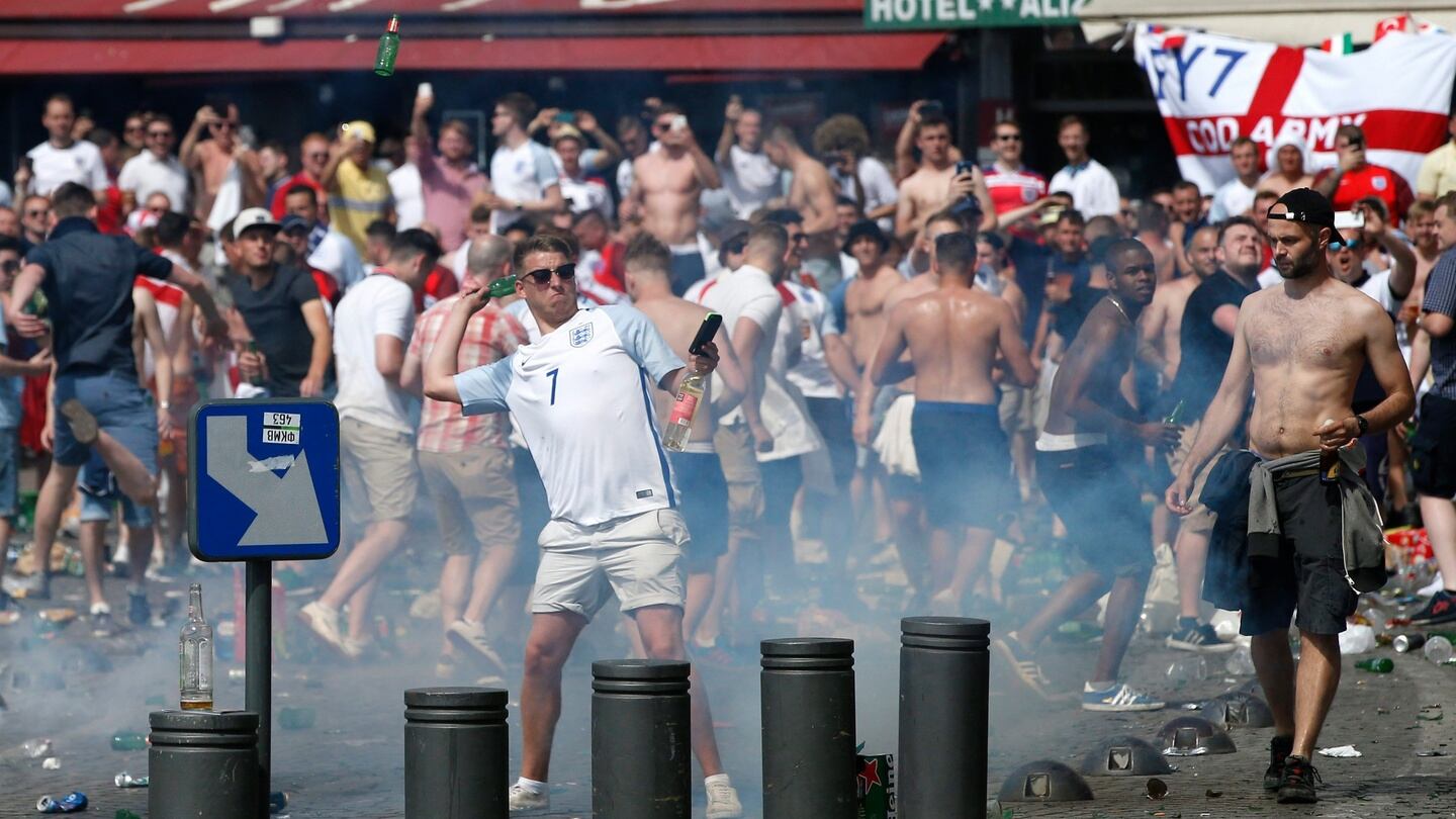 English supporters throw glass bottles as they clash with riot police at the Old Port of Marseille before the UEFA EURO 2016 group B match between England and Russia. Photo: EPA