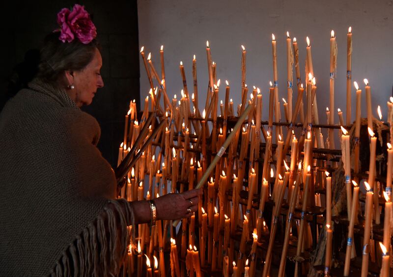 Tradition: A pilgrim lights candles during the annual pilgrimage of El Rocio. Photograph: Cristina Quicler/AFP via Getty