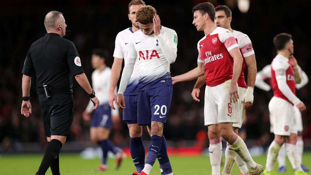 Dele Alli of Tottenham Hotspur reacts after being hit by a water bottle during the Carabao Cup quarter-final match against Arsenal at the Emirates Stadium. Photograph: Alex Morton/Getty Images