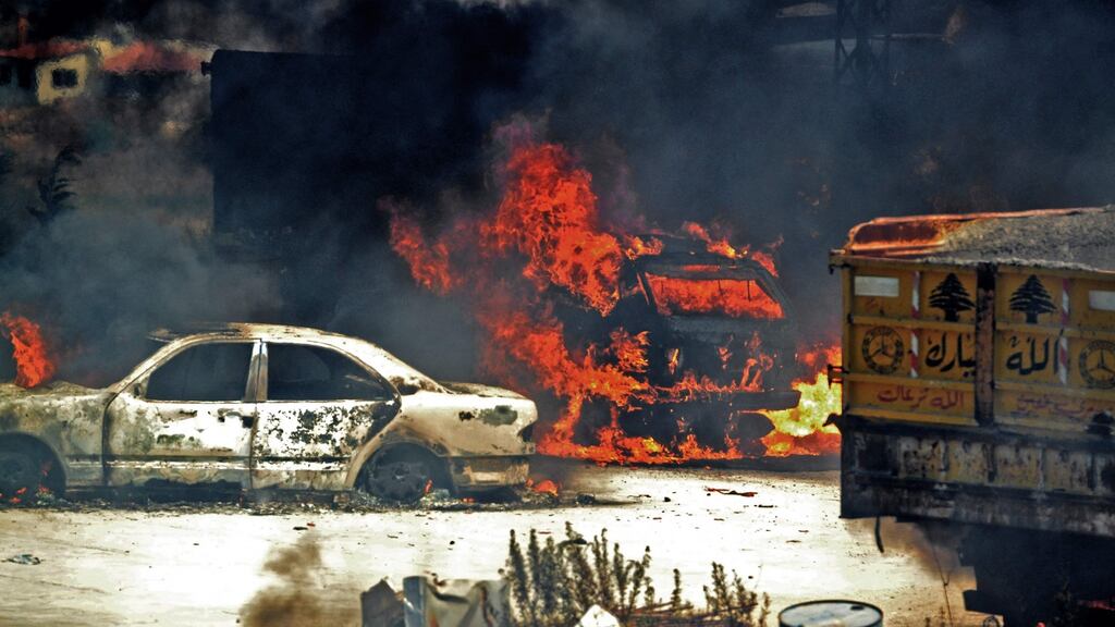 Vehicles burn where the fuel tank exploded in Lebanon’s northern region of Akkar. Photograph: Fathi al-Masri/AFP via Getty