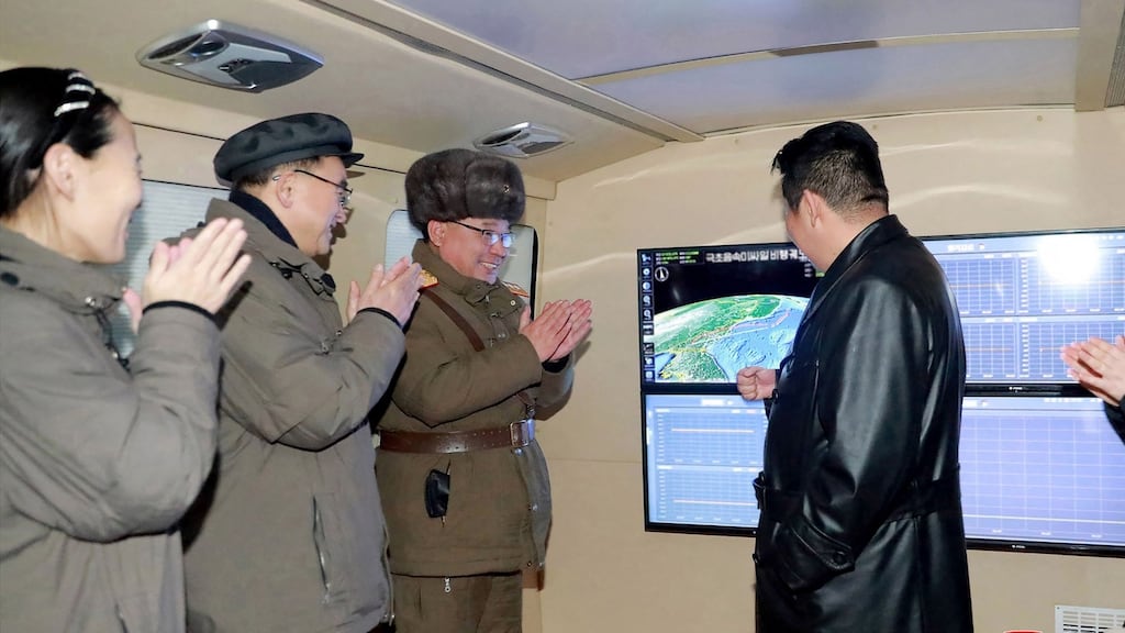 North Korean leader Kim Jong Un (right) speaking with military officials during an observation of a hypersonic missile test-fire. Photograph: Stricken VIA KNS/AFP via Getty Images