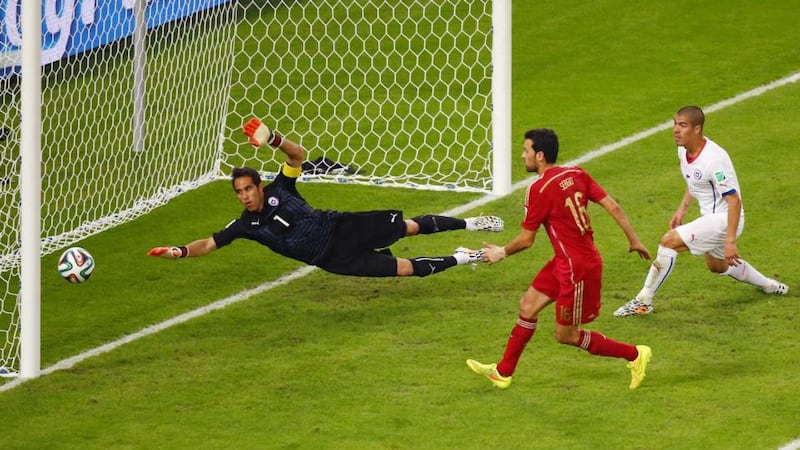 Sergio Busquets of Spain shoots wide of the net against Chile goalkeeper Claudio Bravo during the Fifa World Cup Group B match at the Maracana in Rio de Janeiro. Photograph: Julian Finney/Getty Images