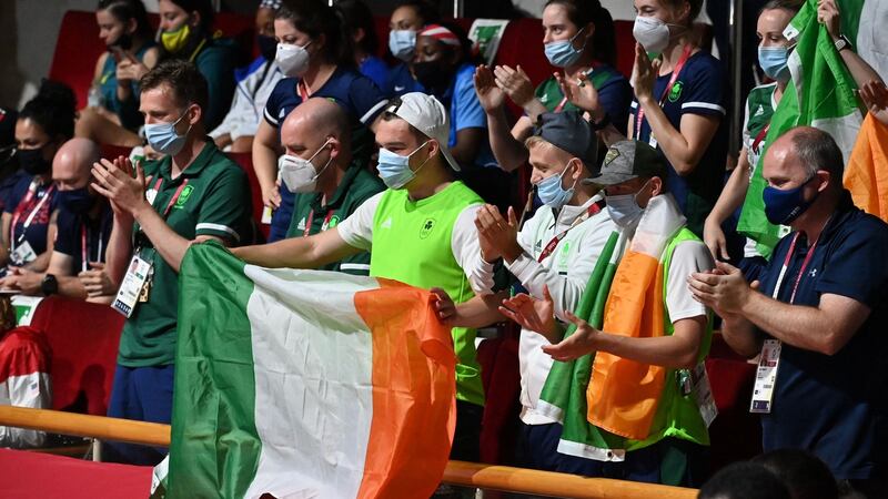 Harrington’s teammates cheer her on during the final. Photo: Luis Robayo/AFP via Getty Images