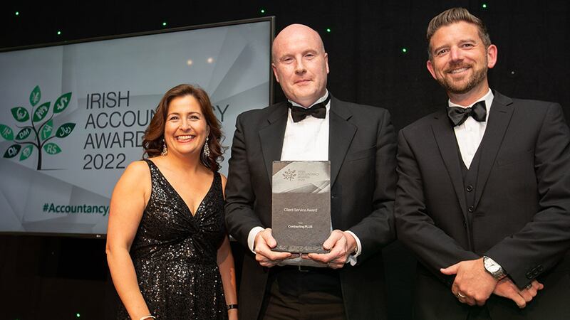 Anthony Doherty, awards judge, presents the Client Service Award to Jimmy Sheehan and Jeanne Murphy, Contracting PLUS.