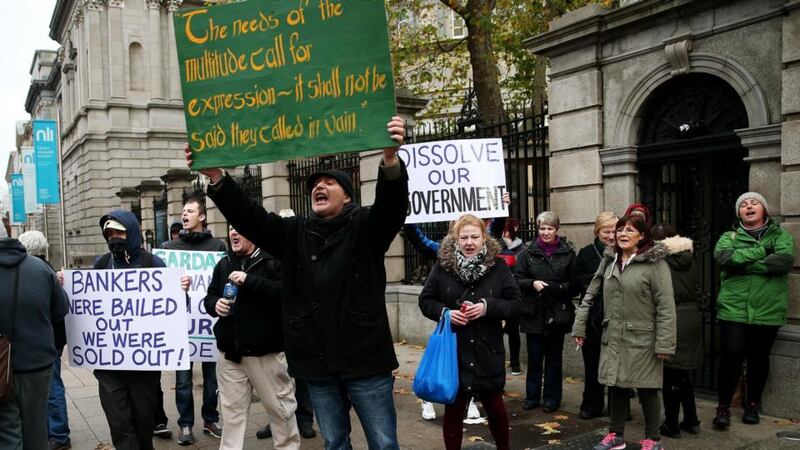 Protestors outside Leinster House in Dublin yesterday as the Government are due to announce new water charges. Photograph: Brian Lawless/PA