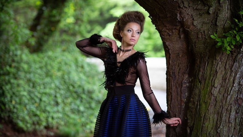 Black beaded neckpiece €145, black feather mesh top €395, black netted and electric blue silk skirt €895. Photograph: Una Williams