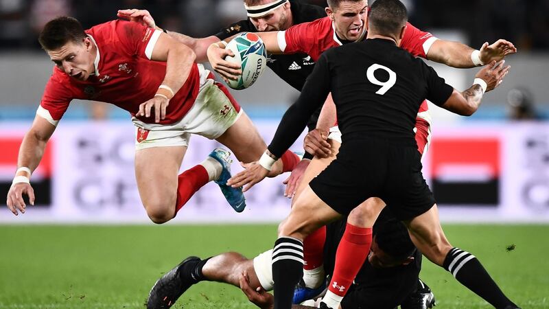 Owen Watkin and Joshua Adams are tackled by Kieran Read. Photo: Anne-Christine Poujoulat/Getty Images