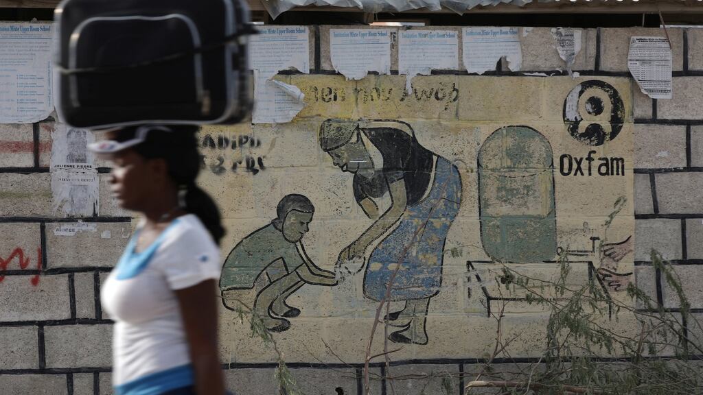 A woman carries a suitcase at Corail, a camp for displaced people on the outskirts of Port-au-Prince, Haiti, after an earthquake in 2010.  Photograph: Andres Martinez Casares/Reuters
