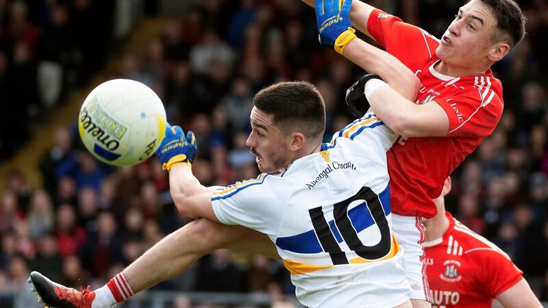 Errigal Ciarán’s Pauric McAnenly and Trillick’s Michael Gallagher battle for possession at Healy Park. Photograph: Evan Logan/Inpho