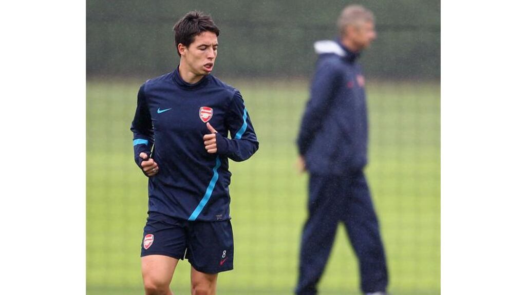 Samir Nasri trains with Arsenal this morning, with Arsene Wenger is the background. The French midfielder will sign for Manchester City pending a medical. – (Photograph: Julian Finney/Getty Images).