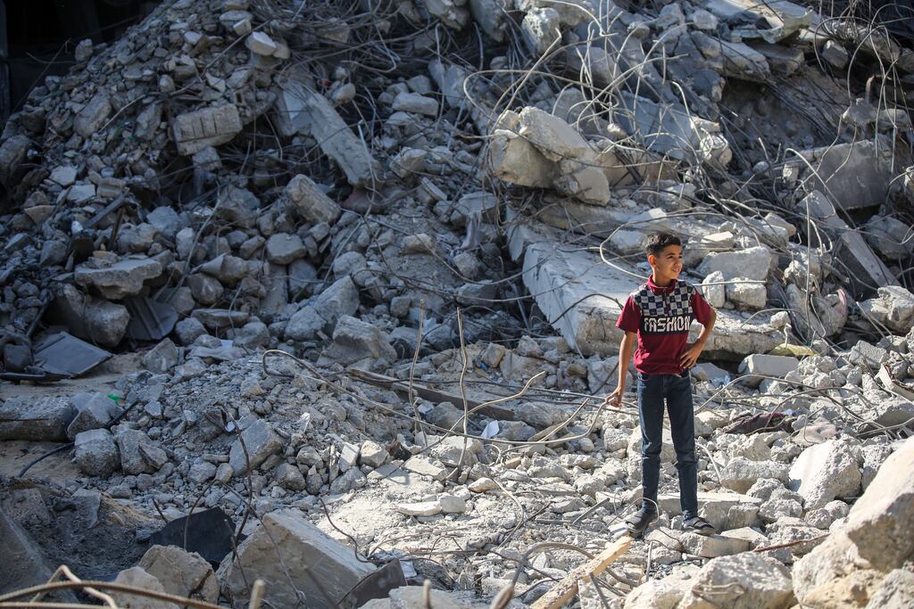 People search for victims in buildings destroyed during Israeli air raids in Gaza. Photograph: Ahmad Hasaballah/Getty Images