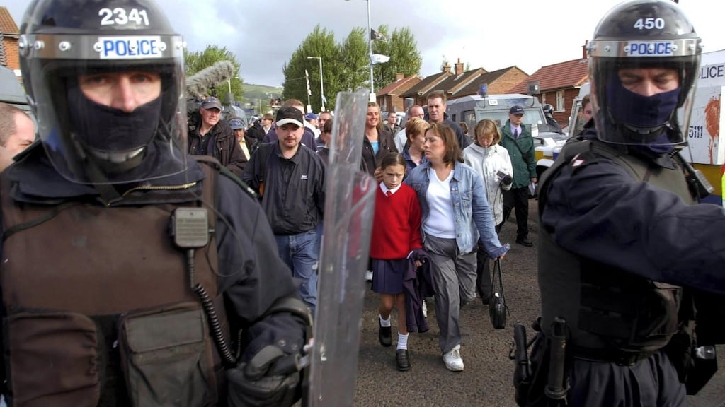 Riot police ahead of people making their way to school on the fourth day of the Ardoyne road dispute, in which children attending the Holy Cross primary school had to make their way past loyalists living in the area. File photograph: Jason South