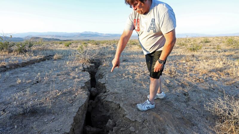 A man looks into a fissure that opened in the desert during a powerful earthquake that struck Southern California, near the city of Ridgecrest on July 4th. Photograph: David McNew/Reuters