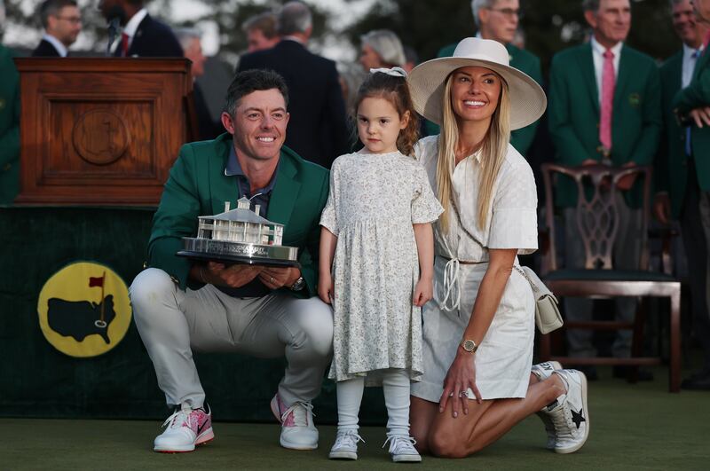 Rory McIlroy with daughter Poppy and wife Erica Stoll holding the Masters trophy in Augusta. Photograph: Michael Reaves/Getty Images