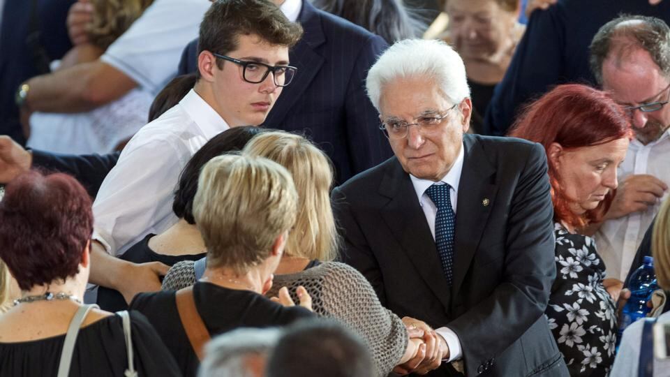 Italian President Sergio Mattarella consoles a woman after a funeral service for victims of the earthquake inside a gym in Ascoli Piceno, Italy. Photograph: Adamo Di Loreto/Reuters