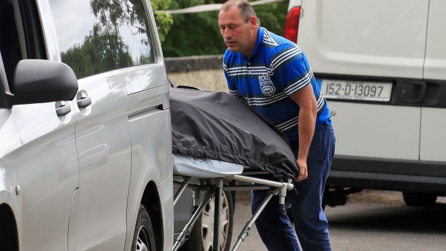 Human remains are removed from the scene of a house fire at Tully East, Co Kildare, in which two men died last night. Photograph: Colin Keegan/Collins Dublin.